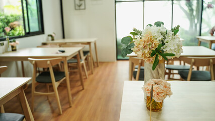 flowers in pot, table and chairs
