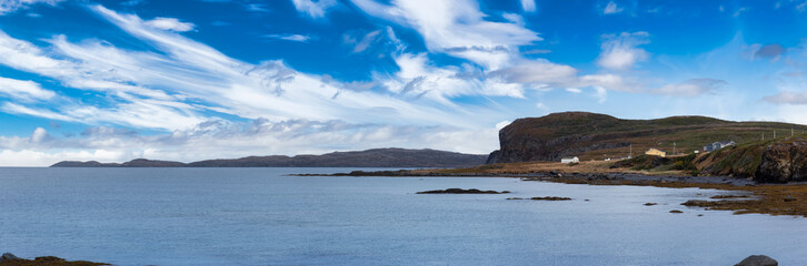 Small town on the Atlantic Ocean Coast. Blue Cloudy Sky Art Render. Taken in Hay Cove, Northern Newfounland, Canada.