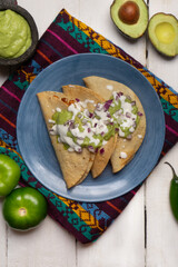 Fried tacos with guacamole and sour cream on white background. Mexican food