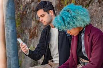 young couple looking at mobile phone