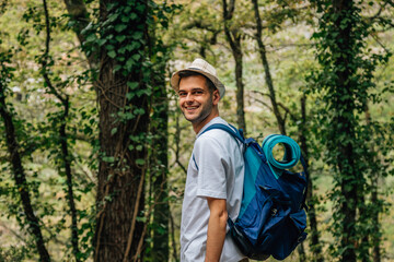 Obraz premium young man with backpack in nature