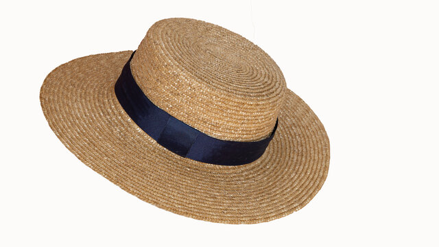 Beautiful straw hat with ribbon and bow on summer beach hat. White background from side view