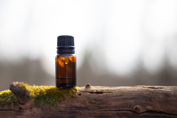 Selective focus shot of a small medial bottle on a tree branch