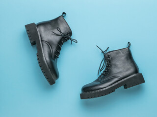 Brutal leather shoes with laces on a blue background.