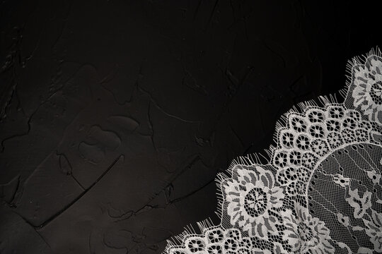 Black background with white lace element inspired by vintage concept