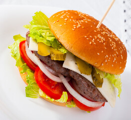 Appetizing double cheeseburger with two grilled beef patties. High quality photo