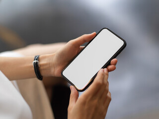 Close up view of female using smartphone include clipping path screen in her hands