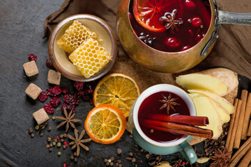 Mulled wine, blue pine tree branch and spices on wooden background