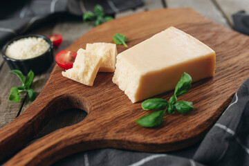 Italian cuisine concept. Parmesan Cheese chunks, cherry tomatos, basil leaves
