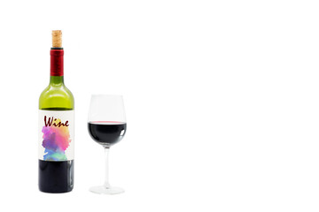 Bottle of red wine with colorful generic label and a crystal glass with wine. White background.