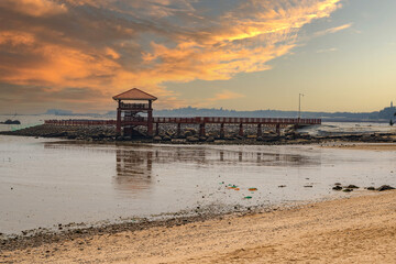 Beach and sea pier under the sunset by the sea
