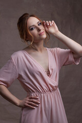 Fototapeta premium young beautiful Caucasian woman, in a pink dress