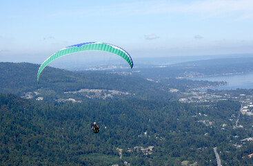 Para gliders catching the warm air up draft from Poo Poo Point to stay airborne. 