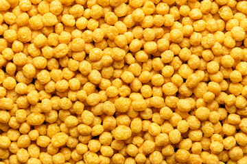 Breakfast cereals with honey, background, top view. Corn cereal balls, close-up