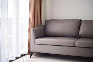 Brown sofa in white room.