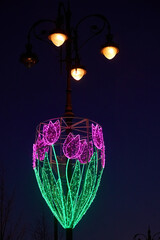 illumination of night city street with garlands and lanterns