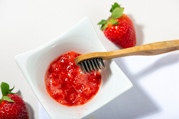 Strawberry for teeth cleaning. DIY homemade personal hygiene products.