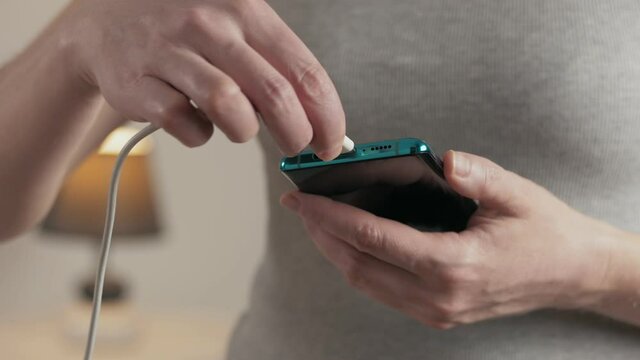 Close-up of the charging connection to phone. Phone charging port. Charging your phone by wire.