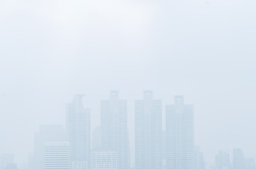 Cityscape in the mist, tall building in thick mist, uncleared or blurred image view, image with blank space area for copy and design.