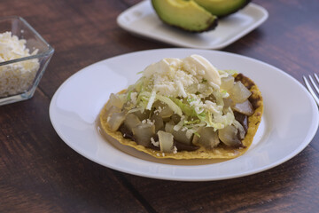 Traditional Mexican food.Beef leg toast with cream, lettuce and cheese, accompanied by avocado slices.