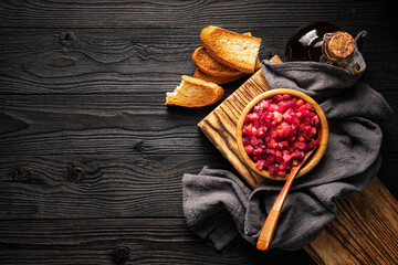 vegetable salad and toasted bread on wooden background top view, copy space