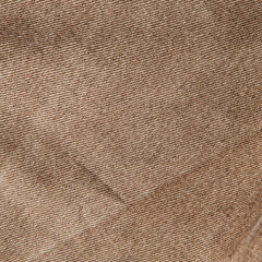 fabric grunge background, real cotton denim brown, wrinkled, frayed, close