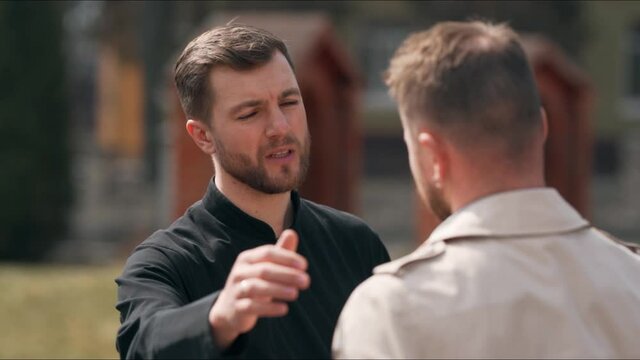 The priest listens to the male parishioner and supports him with advice