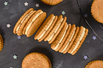 Cream filled sandwich cookies on dark background