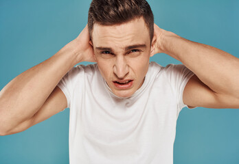 Man in white t-shirt cropped view of emotion displeasure studio