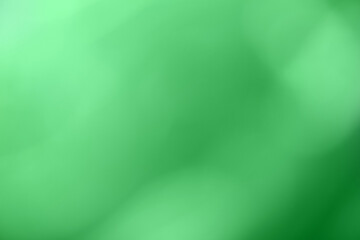 Blurred green and emerald background. Defocused art abstract olive gradient backdrop with blur and bokeh.