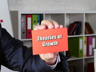 Conceptual photo about Theories of Growth with handwritten phrase.