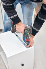 Handyman worker assembling furniture and fixing it.