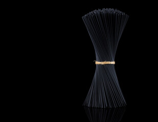Bouquet, raw, black pasta, spaghetti, on a black background, no people, horizontal,