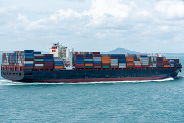 Cargo container ship departing from port of Singapore. She is beginning voyage on her international...