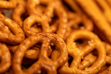 Salted breadsticks and salted pretzels scattered on the table.