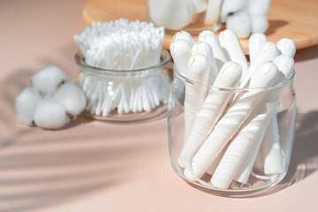 Fototapeta na wymiar Cotton tampons and ear buds on paper background