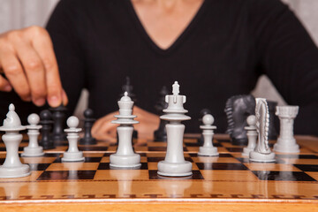  Woman playing chess game makes his move. Concept of business strategy and tactic.
