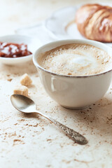  Coffee with milk on bright stone background. Close up.