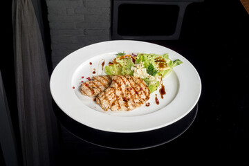Turkey schnitzel with fresh herbs sauce on a white plate