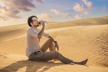 Man feels thirst and drinks water in the desert