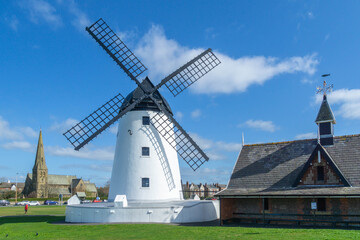 Fototapeta na wymiar White windmill and church in the town of Lytham in Lancashire