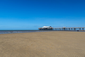 Fototapeta na wymiar Blackpool pier and an empty beach during the covid lockdown at lowtide