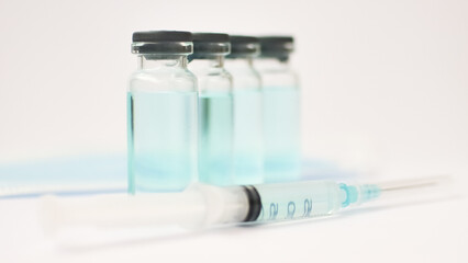 Medical ampoules and insulin syringe isolated on white background, vaccination concept