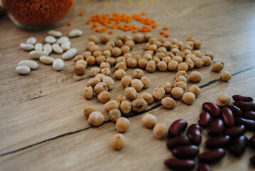 Lentils, millet, buckwheat and beans are scattered on the table.