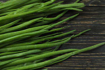 Fresh green onion on wooden background, close up