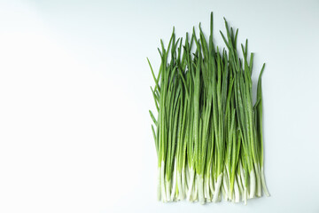 Fresh green onion with water drops on white background
