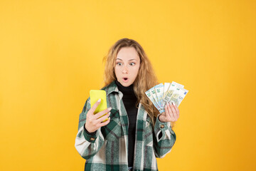 pretty woman with euro bills and smarpthone