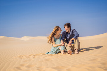 Fototapeta premium Happy couple healthy lifestyle affectionate outdoors in nature during hiking travel. Man and woman hikers smiling in mountain desert landscape. Tourism opens after quarantine COVID 19