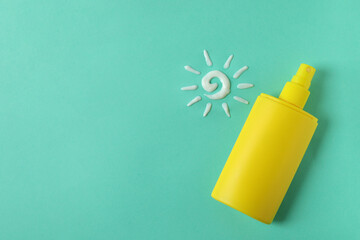 Sunscreen and sun made of cream on mint background