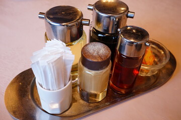 Pepper, soy sauce, vinegar, spicy oil, Toothpick  on the table. Image of table in the restaurant. - コショウ 醤油 お酢 ラー油 つまようじ